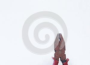 Old rust pliers with red handle isolated on white background