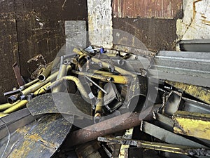 Old and rust steel waste,used metal, piled together in rubbish room