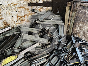 Old and rust steel waste,used metal, piled together in rubbish room