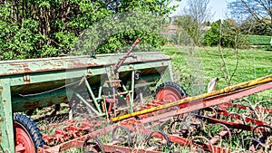 Old, rusted and abandoned farming machinery on a fruit farm