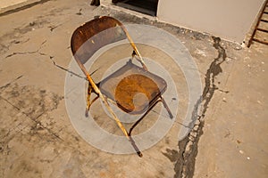 An old rusted abandoned iron chair showing loneliness and solace