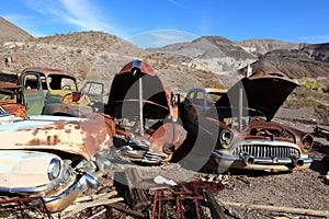 Old rusted cars in junk yard