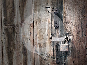 Old rusted door handle and padlock