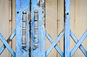 Old rusted lock on blue rusty iron gate