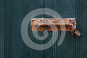 Old rusted lock on a wooden door or shutters