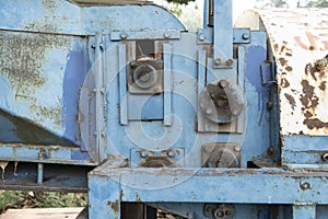 Old rusted machinery painted in blue color kept under sunglight
