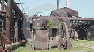 Old rusted metal constructions of the abandoned metallurgic plant.