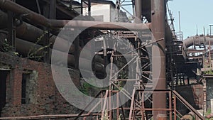 Old rusted metal constructions of the abandoned metallurgic plant.