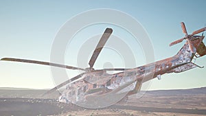 Old rusted military helicopter in the desert at sunset