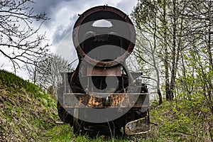 Old rusted steam locomotive abandoned at train cemetery