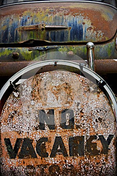 Old rusted vintage Motel no Vacancy Sign and Rusted Car trunk with peeling paint on route 66