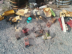 Old, rusted vintage toy vehicles on the ground