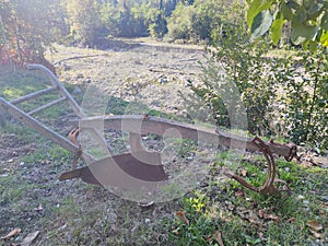 Old rusted wooden iron plow