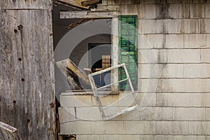 Old rustic abandoned barn with Authorized Personnel Sign on door with broken windows