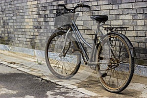 Old Rustic Bicycle Leaning Against a Brick Wall