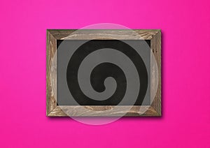 Old rustic black board isolated on a pink background