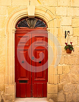 Old rustic door on a mediterranean house of stone