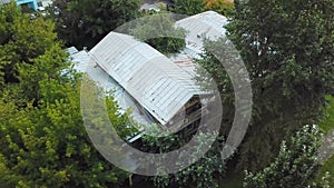 Old rustic house in city center. Stock footage. Old wooden house is located in center of city on background of