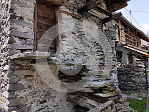 Old rustic house with wooden door in Frasco, Ticino