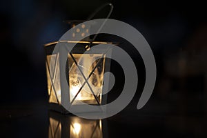 Old rustic lantern in the darkness