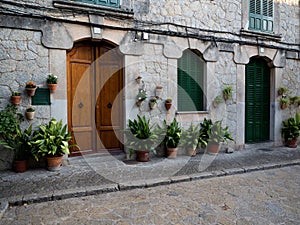 Old rustic mediterranean traditional house facade wall architecture flower decoration Mallorca Balearic Islands Spain