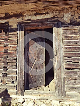 Old rustic rural wood door of a traditional Romania  wood house. Fundata mountains