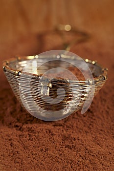Old rustic style silver sieve with cocoa powder