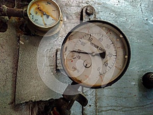 An old rustic vacuum gauge in an old factory, another small gauge behind