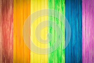 An old rustic wooden board with rainbow colors for gay pride. Ga