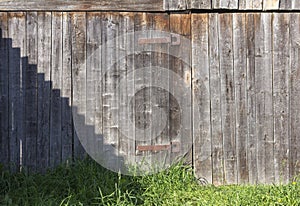 Old rustic wooden gate with rusty hinges