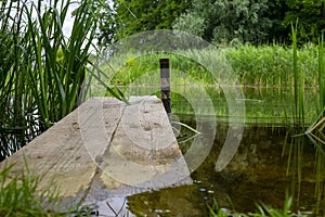 Old rustic wooden jetty on a tranquil lake