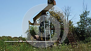 An old rusty abandoned oil rig. Movement of the camera from the bottom up. The concept of the decline of the oil and gas industry