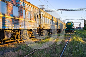 Old, rusty and abandoned passenger cars on the spare track