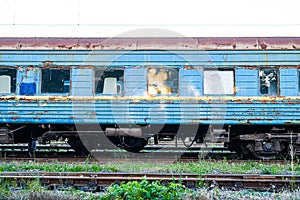 Old, rusty and abandoned passenger cars on the spare track