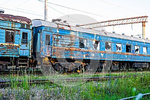 Old, rusty and abandoned passenger cars on the spare track