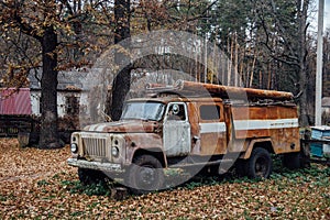 Old rusty abandoned Soviet fire truck in the village