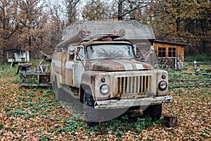 Old rusty abandoned Soviet fire truck in the village