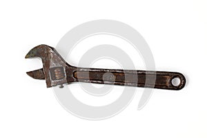 Old rusty adjustable spanner isolated on a white background