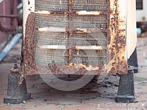 Old rusty air conditioner outdoor unit on house facade