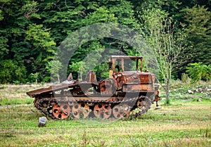 Old rusty all-terrain vehicle on tracks