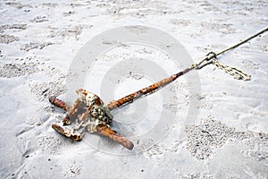 Old rusty anchor on the beach