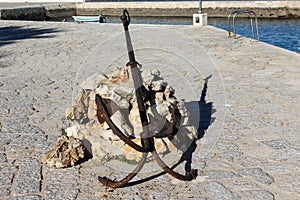 Old rusty anchor in the habor