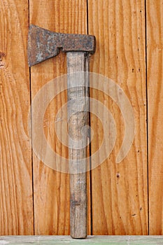 Old, rusty ax with a wooden handle