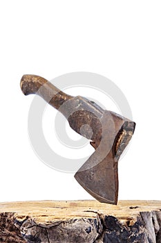 Old rusty axe with wooden handle stuck in the stump