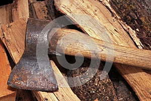 An old rusty axe on the woodshed in the barn