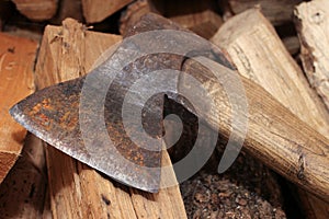 An old rusty axe on the woodshed in the barn