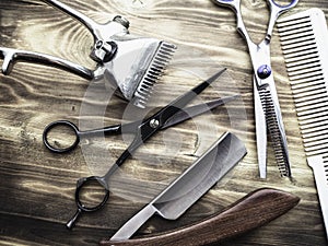 Old rusty barber shop tools on wood background