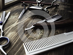 Old rusty barber shop tools on wood background