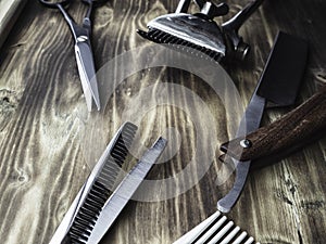 Old rusty barber shop tools on wood background