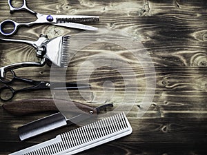 Old rusty barber shop tools on wood background